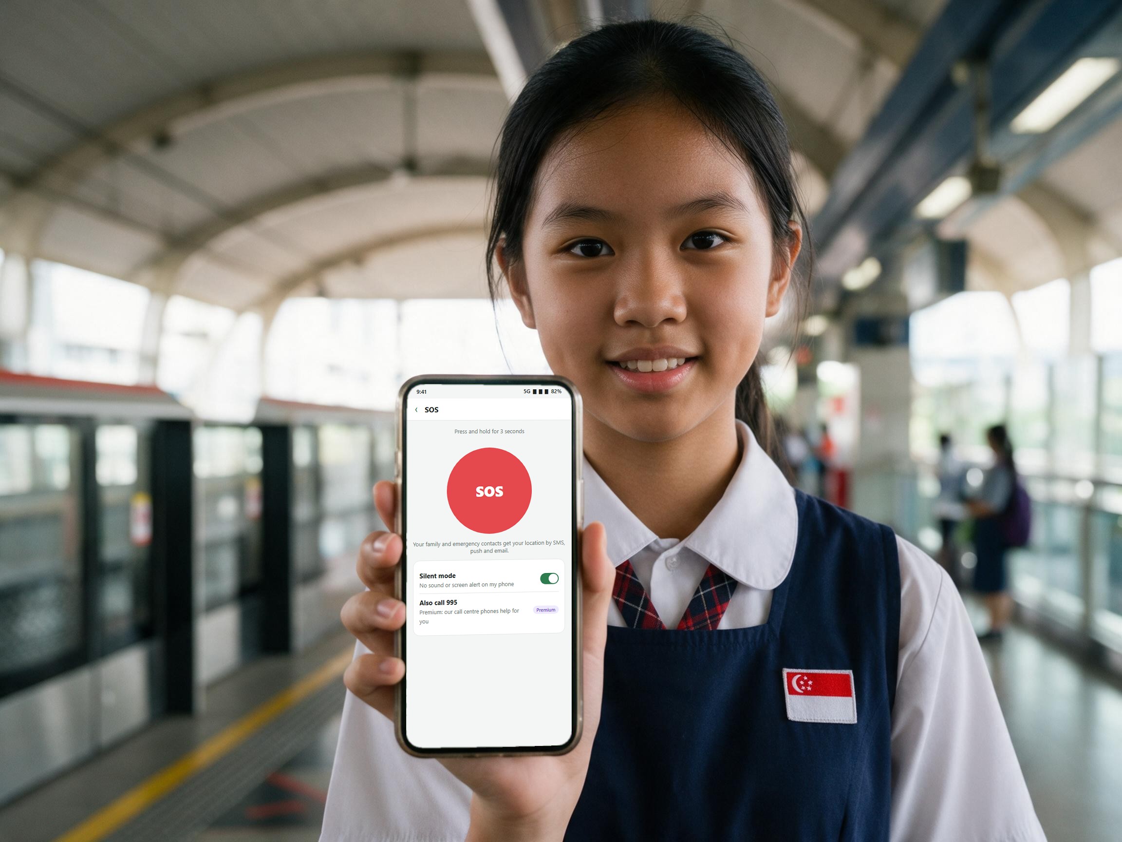 A student showing the Arrivo SOS button at an MRT station